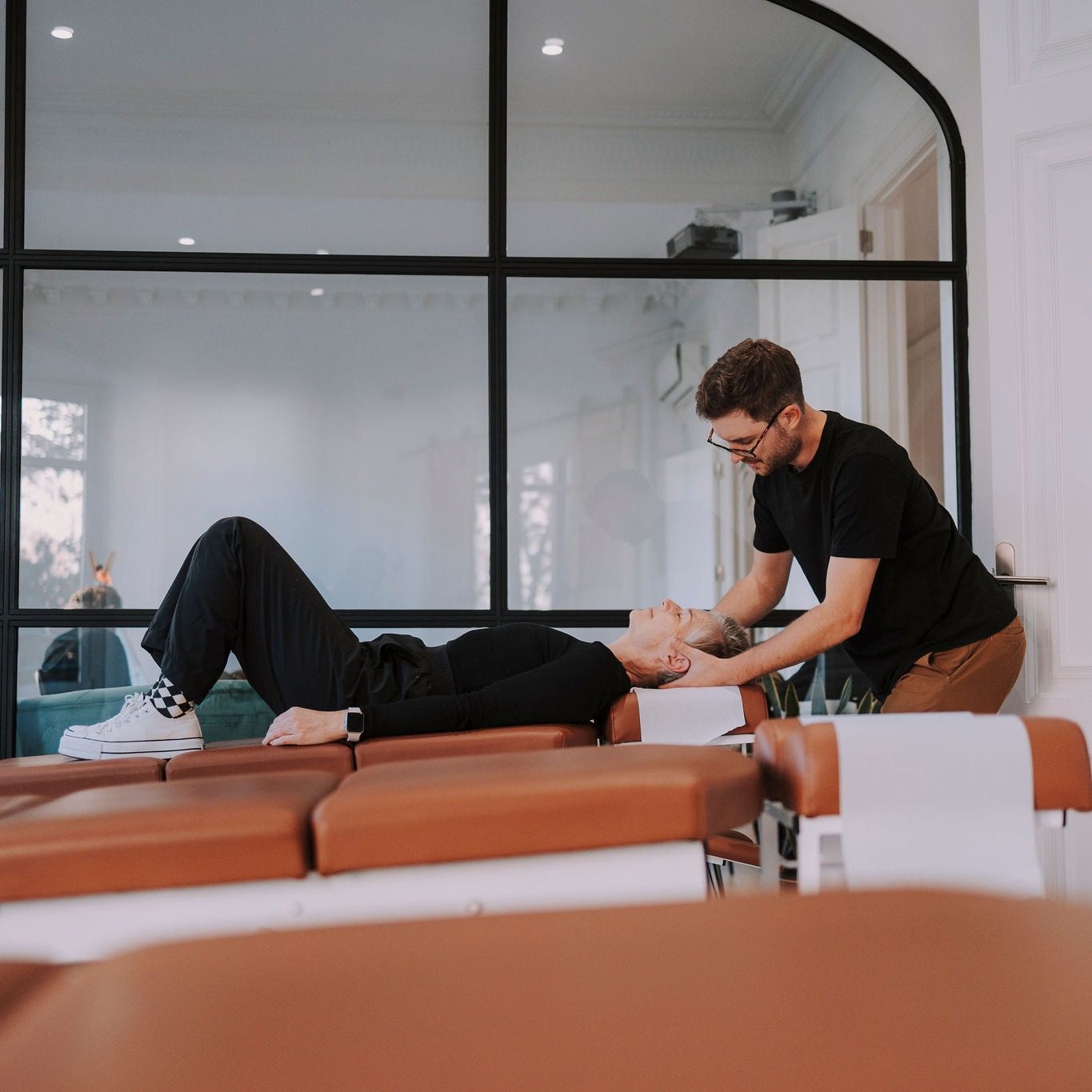 Dr. Francisco Turelli adjusting a practice member lying on the table at illumINNATE Chiropractic Studio, Barcelona